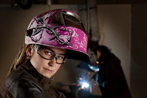 Woman wearing welding helmet