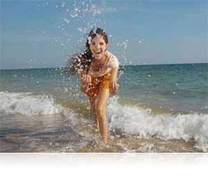 Nikon COOLPIX S33 photo of a girl splashing in the surf showing waterproof feature