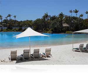 Nikon COOLPIX S3600 photo of a beach with chairs and palm trees in the background showing scene modes